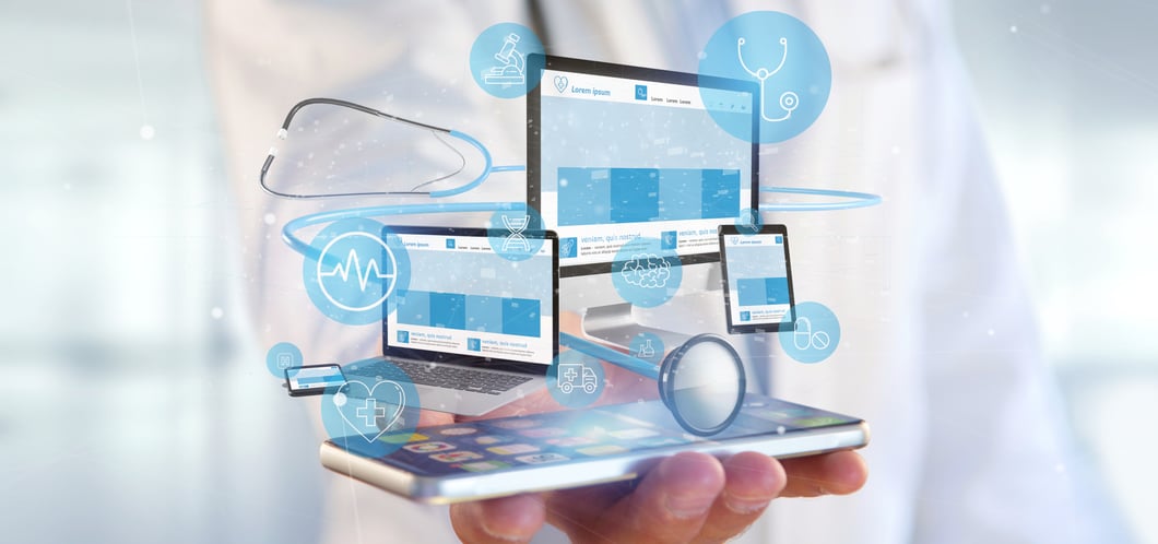 Hand holding a smartphone projecting holographic medical website interfaces across laptop, tablet, and desktop screens with healthcare icons and digital connectivity elements. 