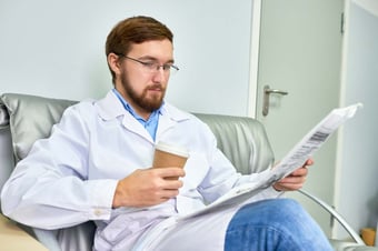  Medical professional reading healthcare tech news stories  