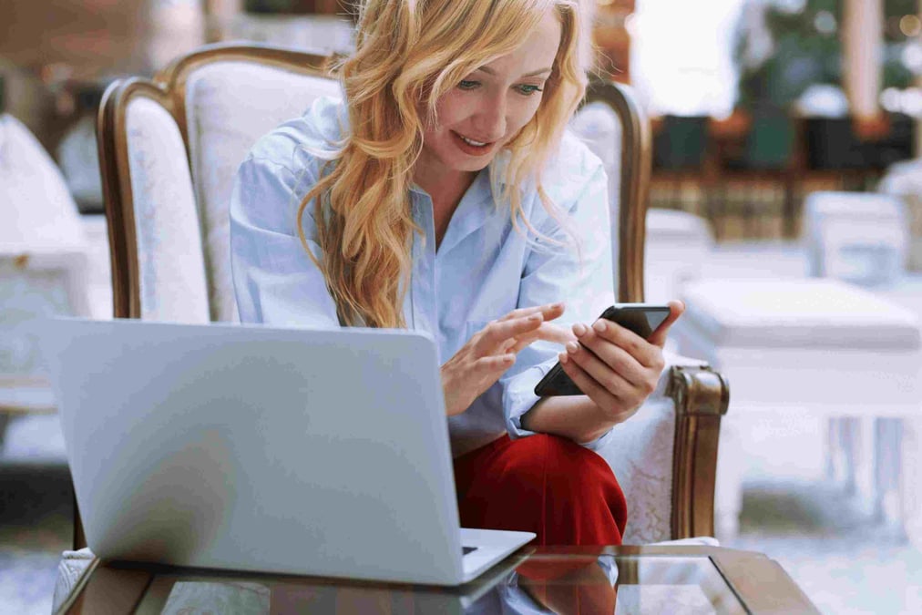 Woman on phone and computer. 