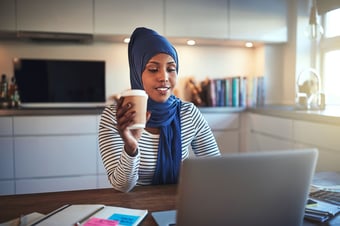 young-arabic-woman-drinking-coffee-and-working-JCBW54R1 