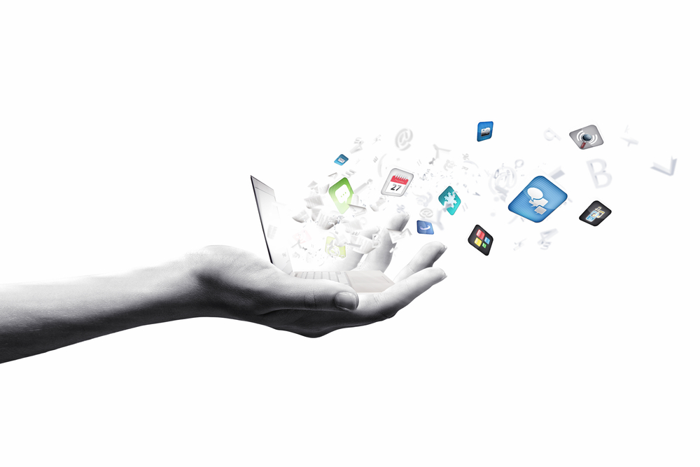Close up of hand with laptop and media icons 