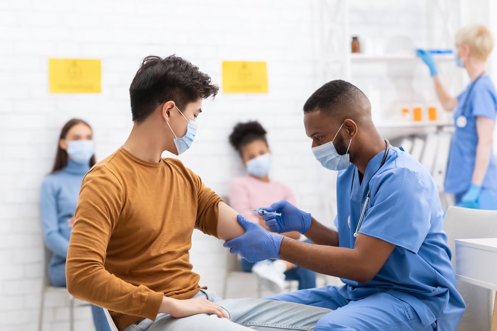 healthcare worker vaccinating patient with COVID-19 vaccine 