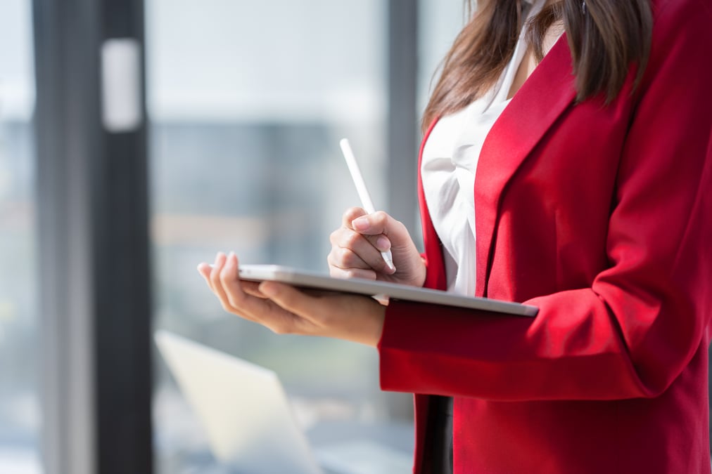 healthcare health tech PR marketing professional looking at top must-haves for B2B marketing on tablet-1 